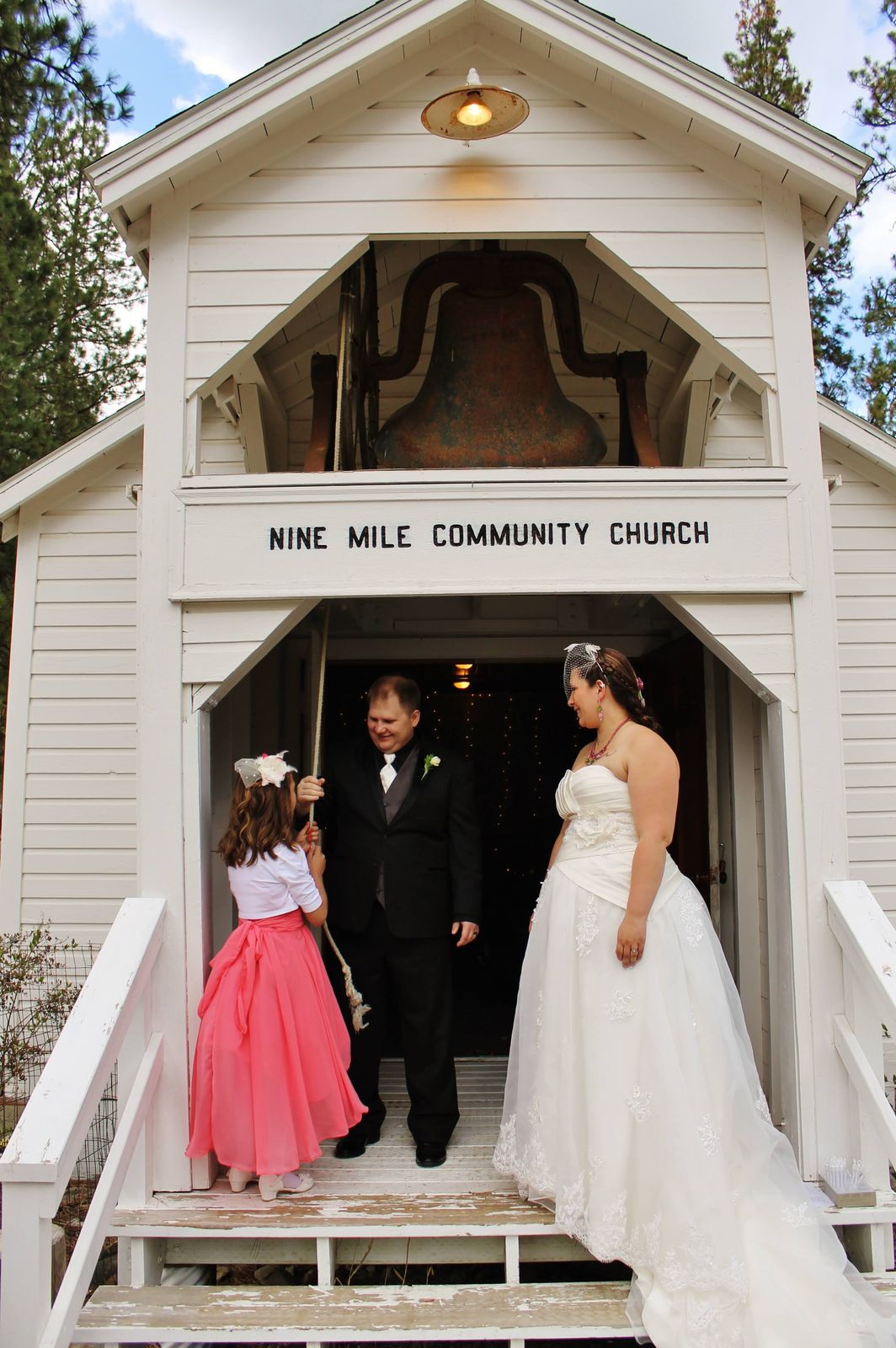 Couple exiting a white community church after the ceremony