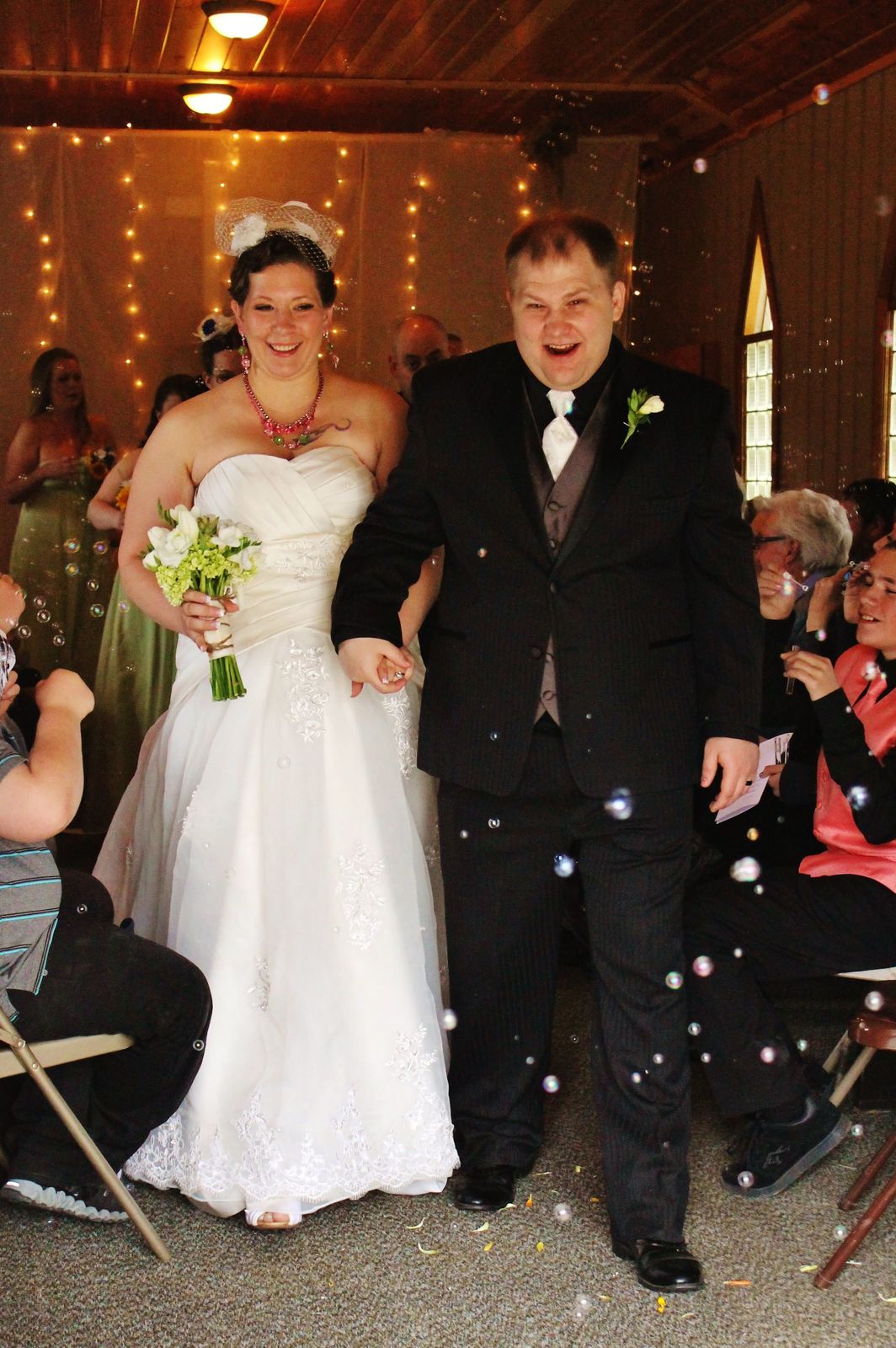 Couple celebrating with guests and confetti